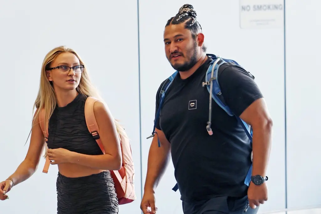 Edwin Castro with a mystery woman on the airport