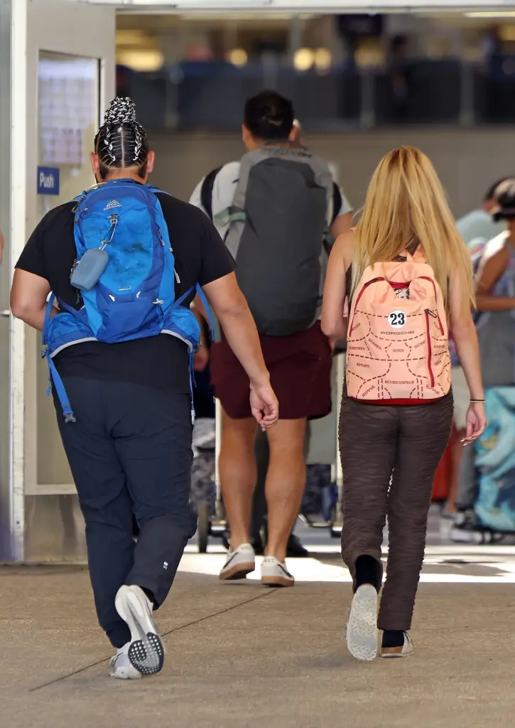 Edwin Castro with a woman on the airport